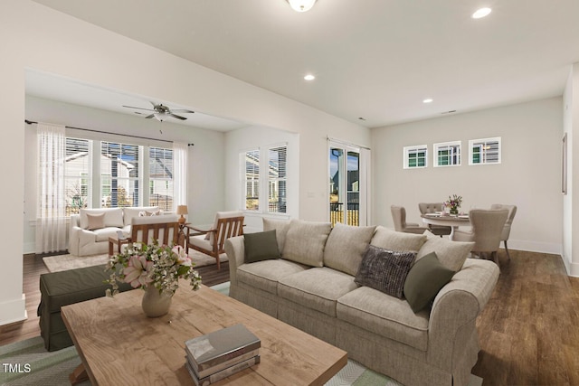 living room featuring ceiling fan, baseboards, wood finished floors, and recessed lighting