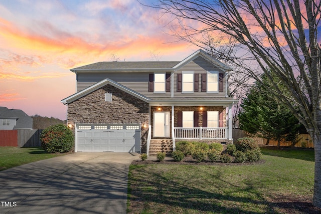 view of front property with a lawn, a garage, and a porch