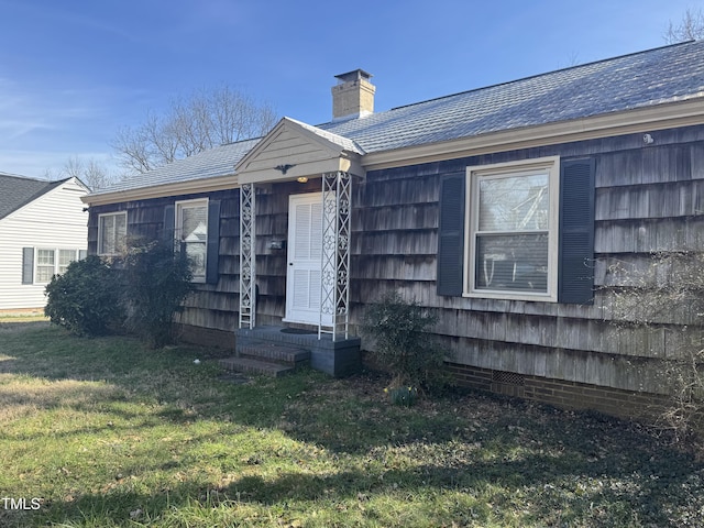 exterior space with a chimney, entry steps, crawl space, and a front yard