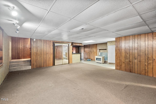 620 Mcghees Mill Rd, Roxboro, NC 27574 - unfurnished living room featuring carpet floors, wood walls, a drop ceiling, and stairs