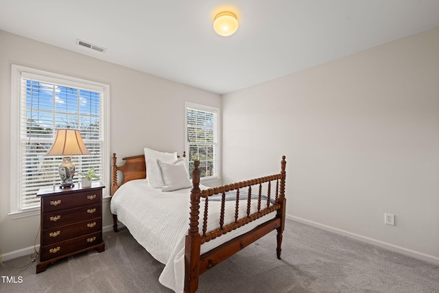 bedroom featuring dark colored carpet, visible vents, and baseboards