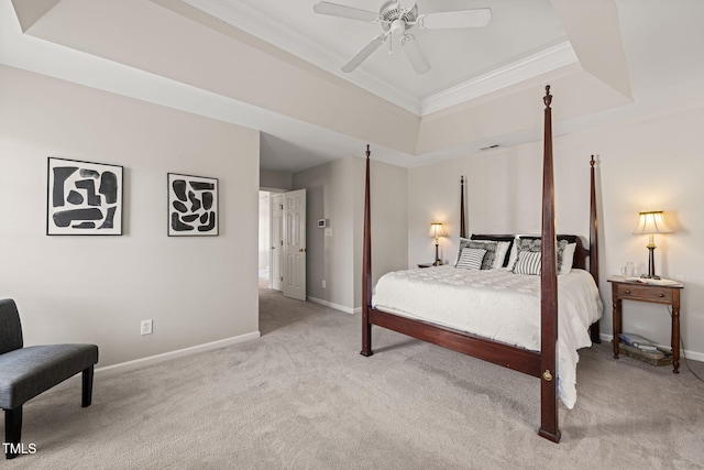 bedroom with a raised ceiling, light carpet, crown molding, and baseboards