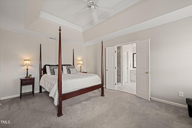 bedroom featuring carpet floors, a tray ceiling, ornamental molding, and baseboards