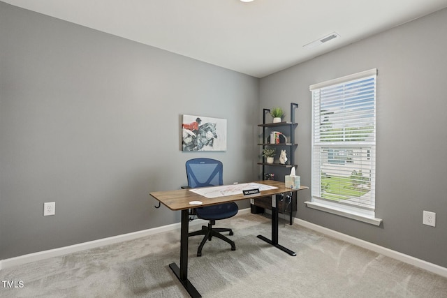 carpeted office featuring visible vents and baseboards