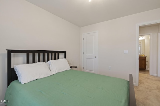 bedroom with light colored carpet and baseboards