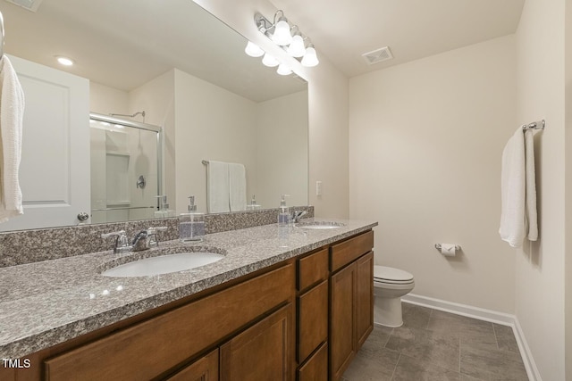 bathroom featuring double vanity, a shower stall, visible vents, and a sink