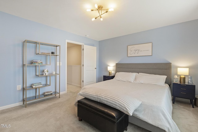 carpeted bedroom featuring a chandelier and baseboards