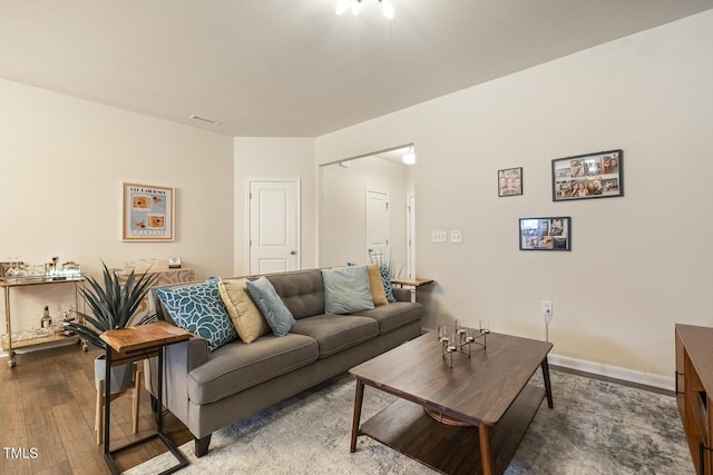 living room featuring hardwood / wood-style flooring and baseboards