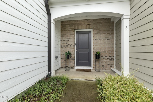 view of exterior entry with a porch