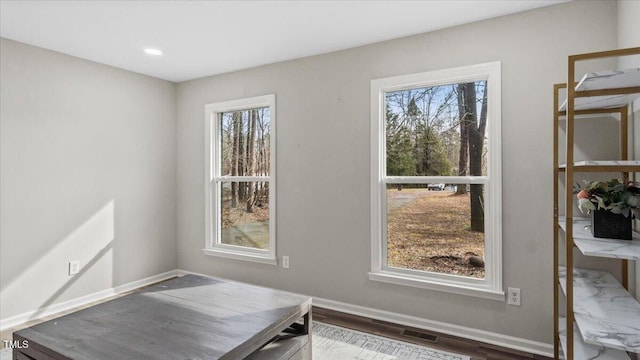 office with visible vents, baseboards, and wood finished floors