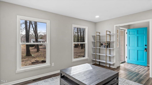 entryway with dark wood-style flooring, visible vents, and baseboards