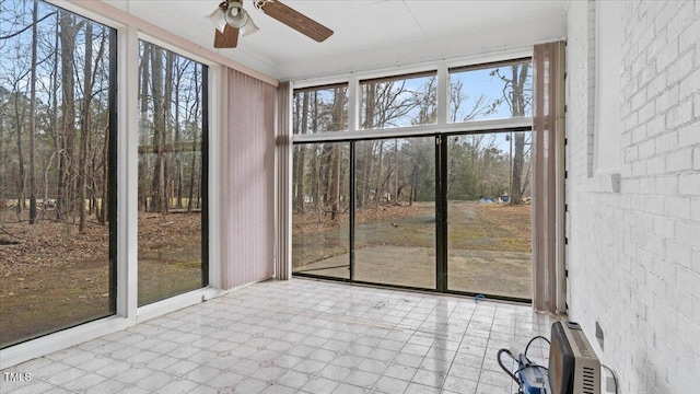 unfurnished sunroom with a ceiling fan