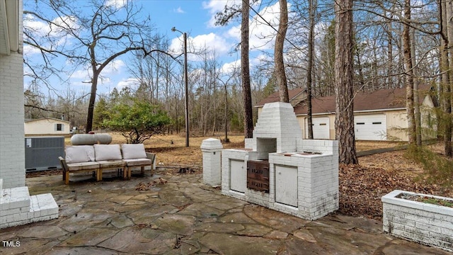 view of patio / terrace featuring central air condition unit, a fireplace, and area for grilling