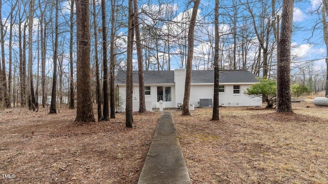 view of front of home with crawl space and central air condition unit