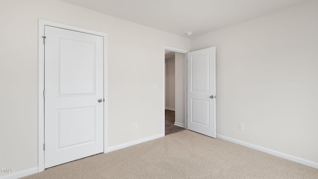 unfurnished bedroom featuring light colored carpet