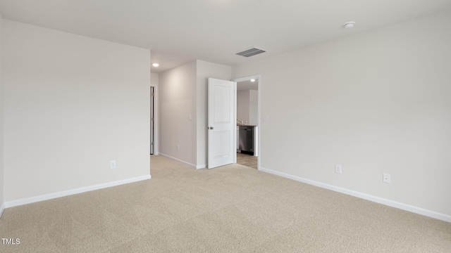 unfurnished bedroom with light colored carpet