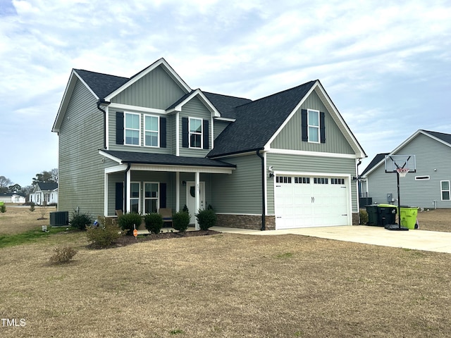 craftsman-style house with roof with shingles, a porch, concrete driveway, stone siding, and central air condition unit