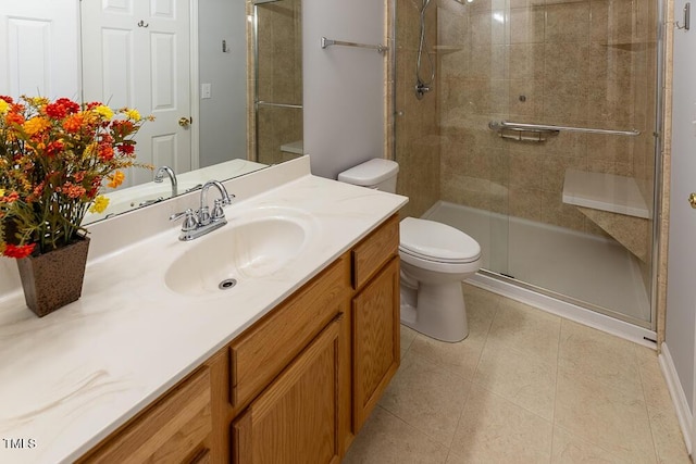 bathroom featuring tile patterned flooring, tiled shower, vanity, and toilet