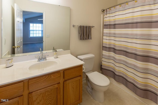 bathroom with toilet, tile patterned flooring, and vanity