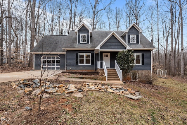 cape cod-style house featuring a garage and driveway