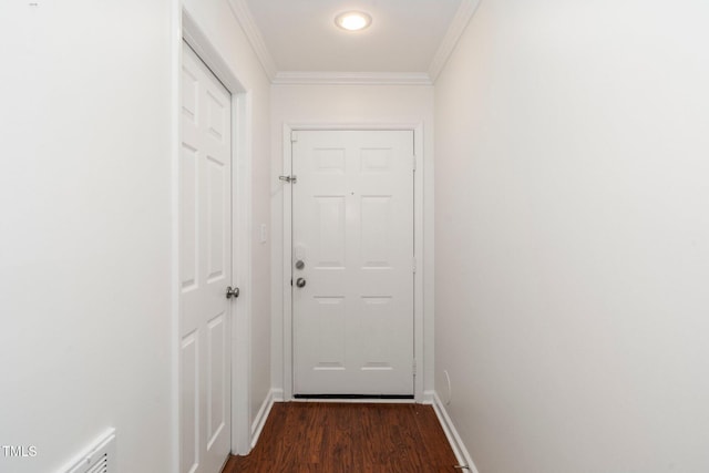 doorway featuring baseboards, ornamental molding, and dark wood finished floors