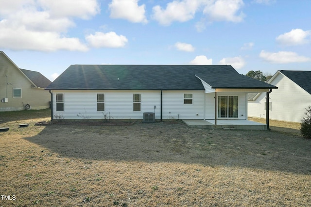 back of house featuring a patio area, a lawn, and central AC