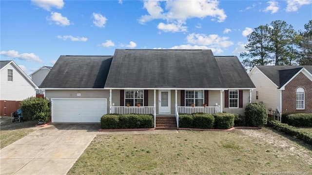 view of front of home featuring a garage, a front yard, a porch, and concrete driveway