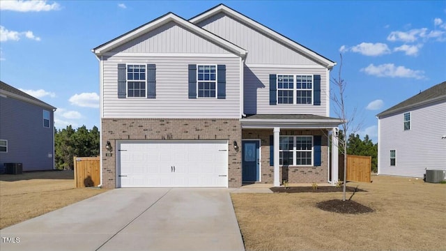 view of front of property with central AC and a garage