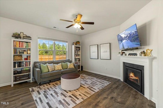 living room featuring dark hardwood / wood-style floors and ceiling fan