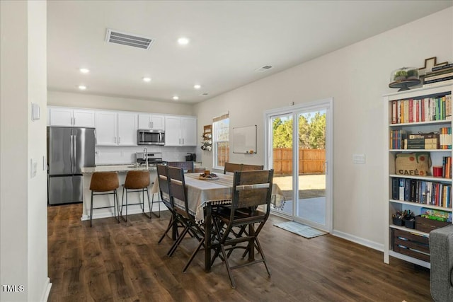 dining area featuring dark wood-type flooring