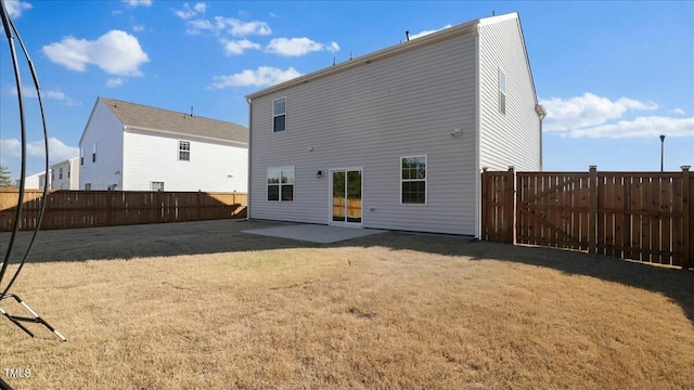 back of property featuring a yard and a patio area