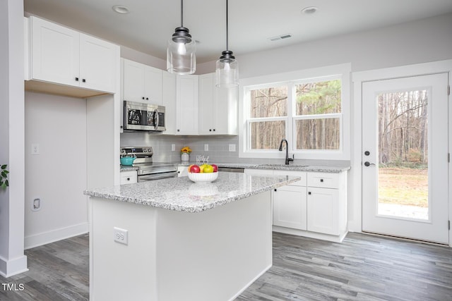 00 Cedar Grove Church Rd, Roxboro, NC 27574 - kitchen with a center island, stainless steel appliances, hanging light fixtures, and white cabinets