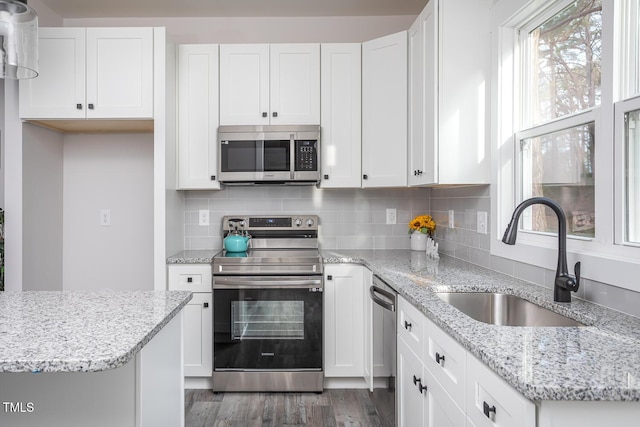00 Cedar Grove Church Rd, Roxboro, NC 27574 - kitchen with appliances with stainless steel finishes, sink, white cabinets, and backsplash