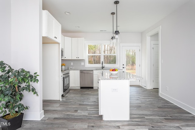 00 Cedar Grove Church Rd, Roxboro, NC 27574 - kitchen with white cabinets, hanging light fixtures, appliances with stainless steel finishes, and a center island