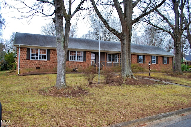 ranch-style home with covered porch and a front yard