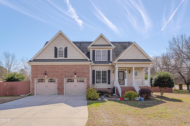 view of front facade with driveway, fence, a front lawn, and a porch