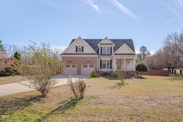 traditional-style home with concrete driveway, covered porch, fence, a front lawn, and brick siding