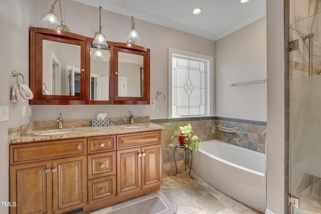 bathroom with double vanity, ornamental molding, a sink, and a bath