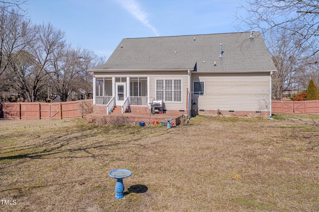 back of house with a yard, a shingled roof, a sunroom, crawl space, and a fenced backyard