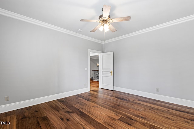 spare room with dark wood finished floors, a ceiling fan, baseboards, and ornamental molding