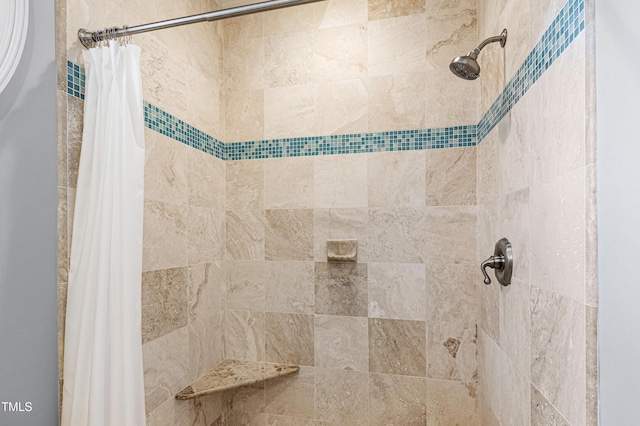 full bathroom featuring tiled shower