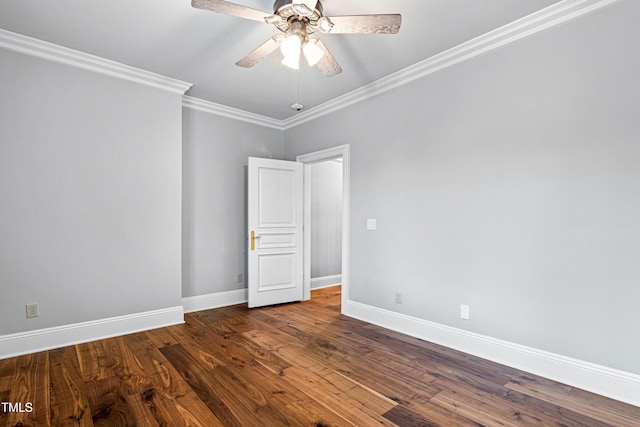 spare room with ornamental molding, a ceiling fan, baseboards, and wood finished floors