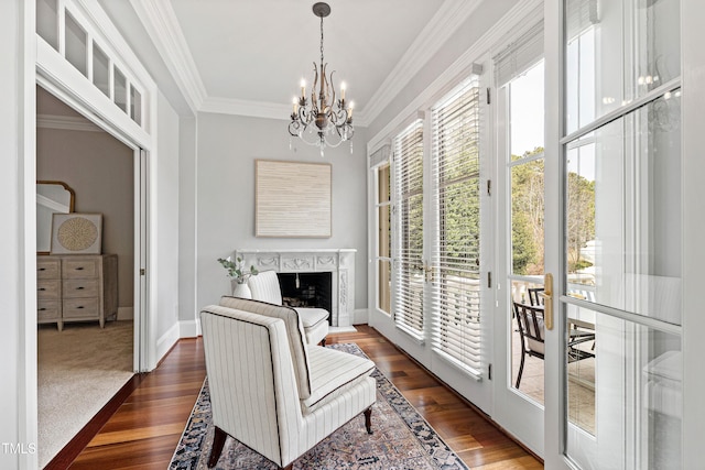 interior space featuring dark wood finished floors, a chandelier, a fireplace, and crown molding