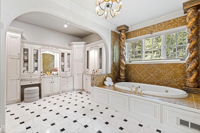 bathroom featuring vanity, visible vents, an inviting chandelier, ornamental molding, and a bath