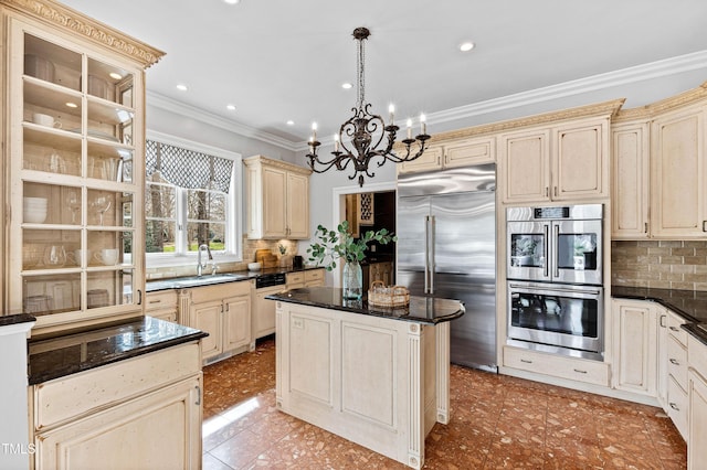 kitchen featuring a sink, cream cabinetry, tasteful backsplash, and stainless steel appliances