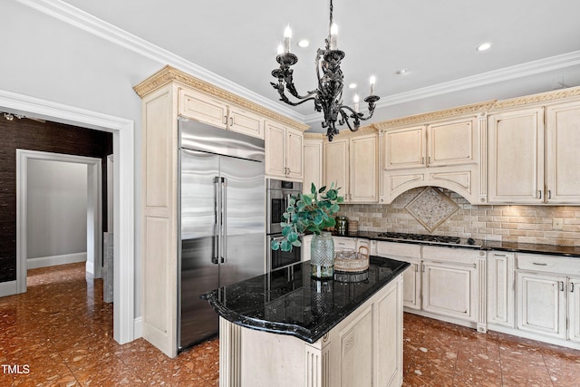 kitchen with backsplash, crown molding, cream cabinetry, and appliances with stainless steel finishes