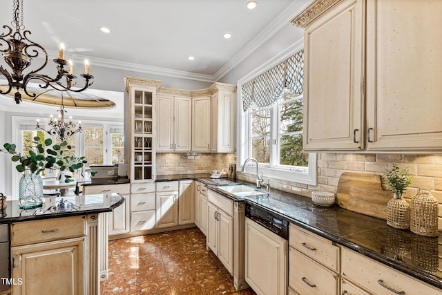 kitchen featuring ornamental molding, a sink, paneled dishwasher, dark countertops, and an inviting chandelier