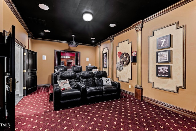 carpeted cinema room featuring crown molding and baseboards