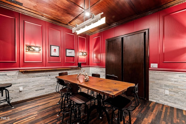 dining space featuring wood ceiling, dark wood-style flooring, and a decorative wall