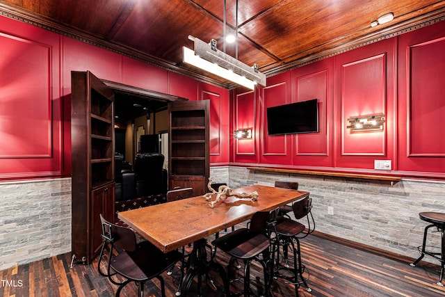 dining room with wood ceiling, dark wood-style flooring, and a decorative wall